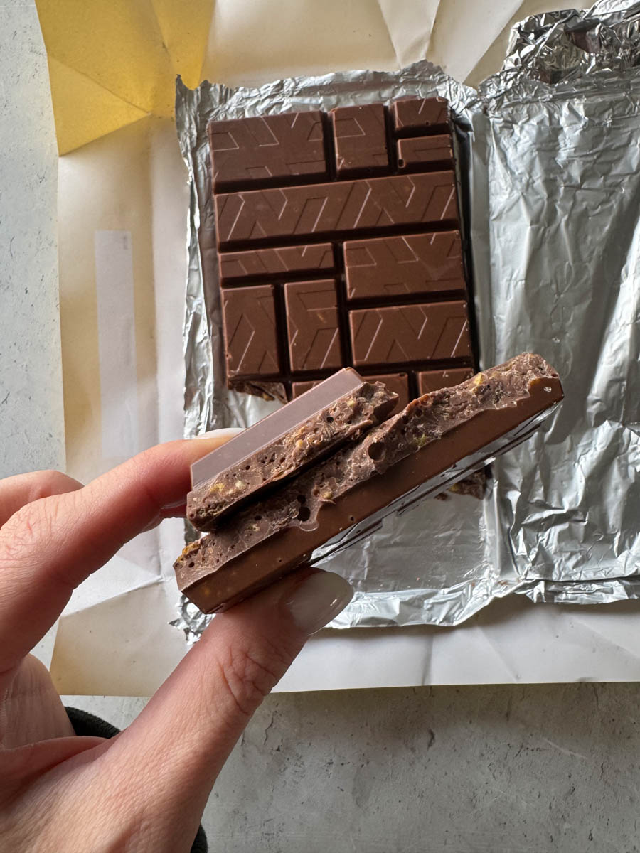 taking a piece from the chocolate bar