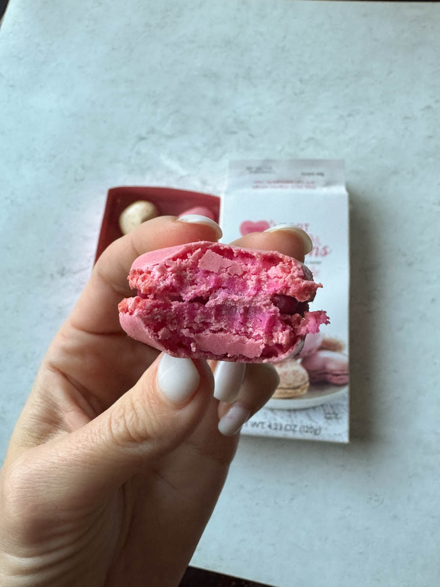 bite into a pink macaron