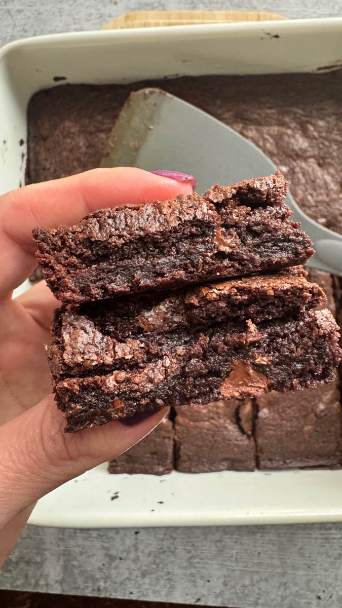 holding a piece of brownie in hand