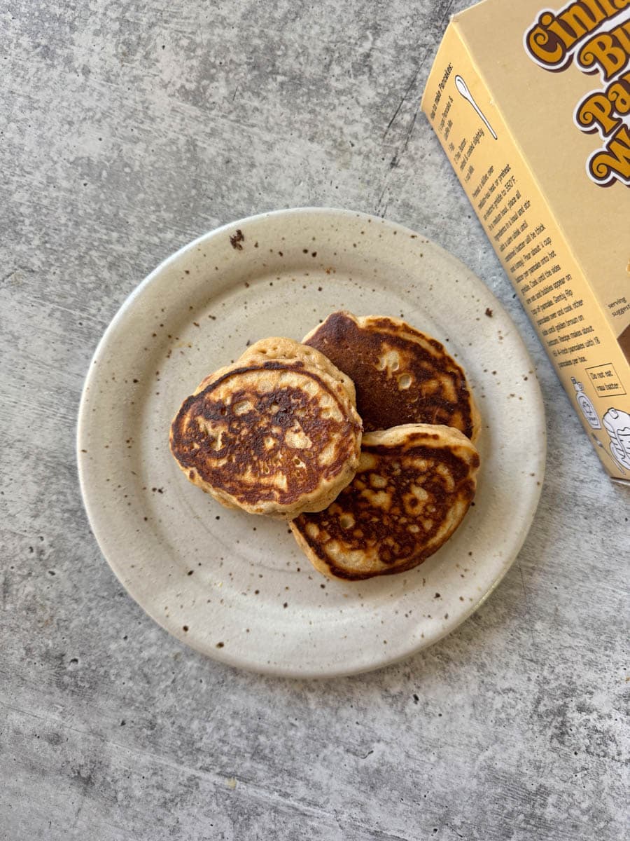 cooked pancakes on the plate next to the box