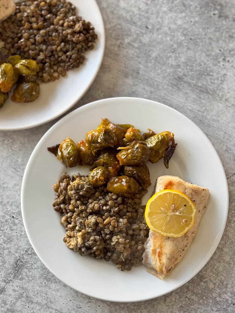 cod, lentils and Brussels sprouts on the plate