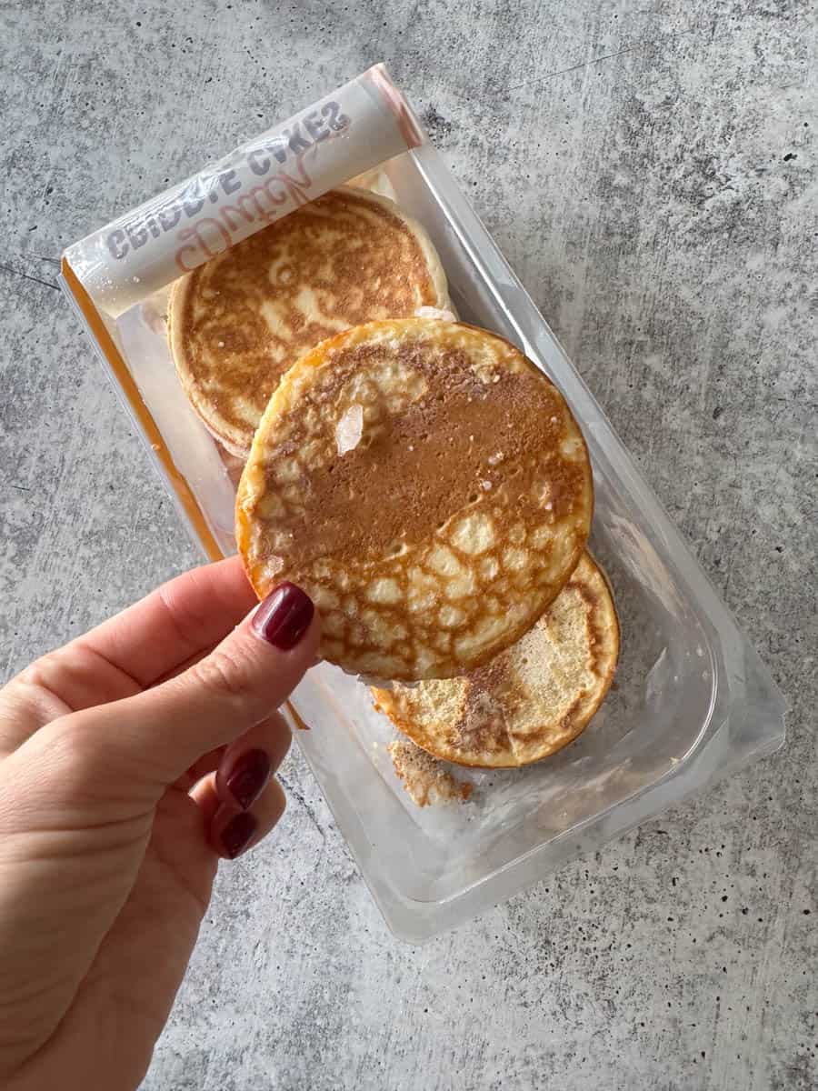 holding a pancake in hand