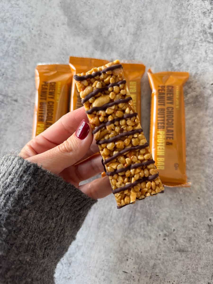 trader joe's chewy chocolate and peanut butter bars in hand