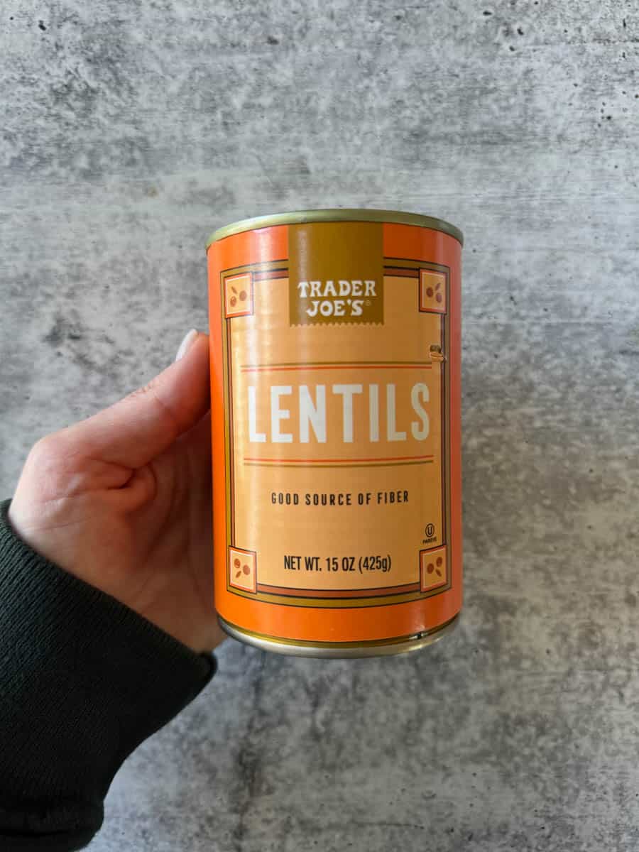 a can of lentils in hand