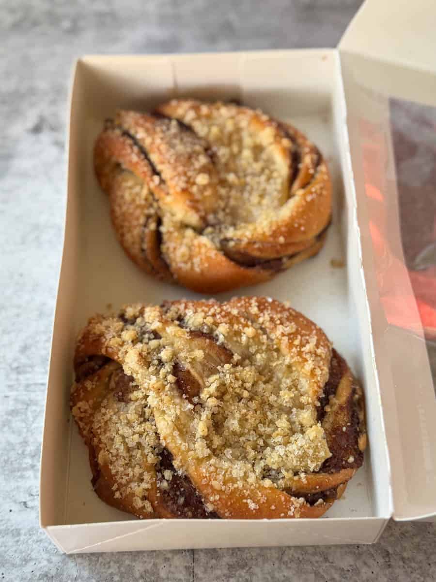 two apple cinnamon buns in the box
