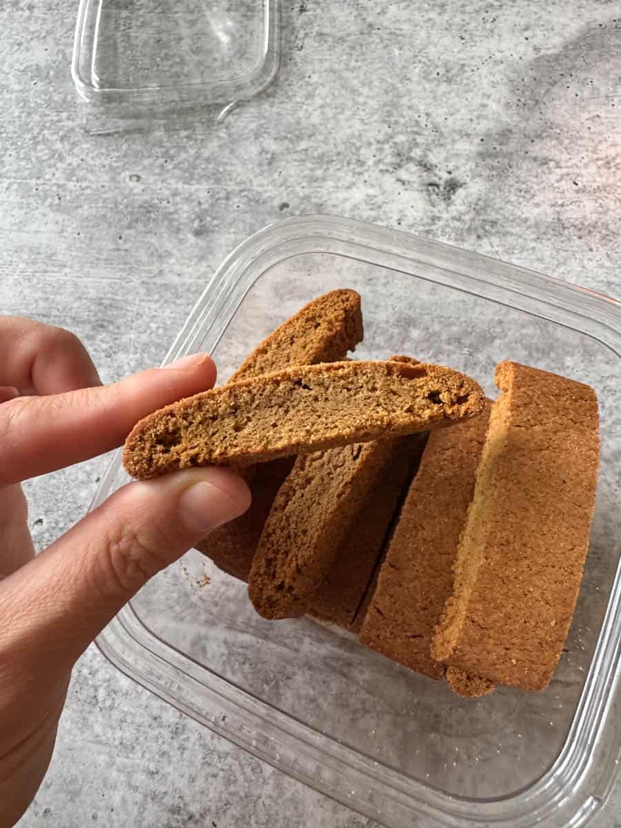 holding a pumpkin biscotti in hand