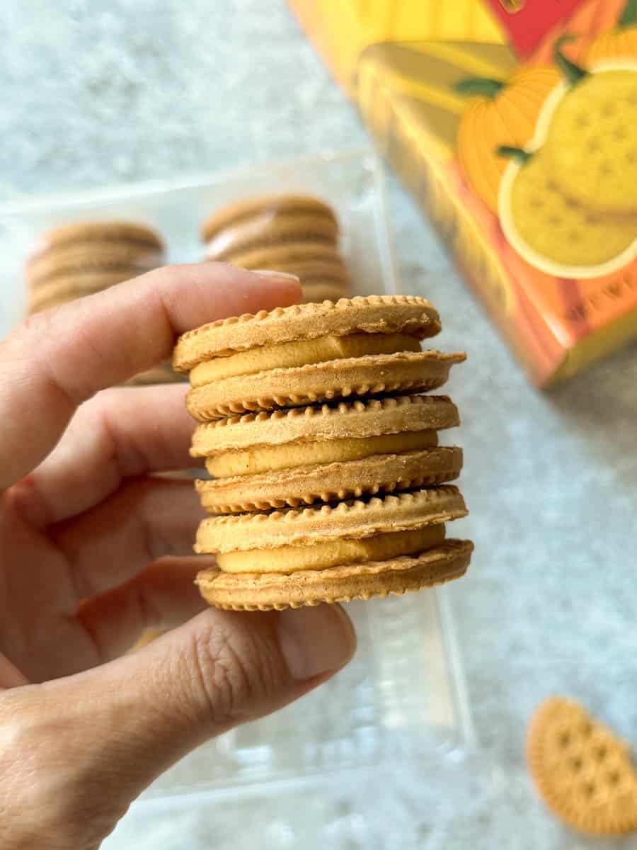 a stack of trader joe's pumpkin cookies in hand