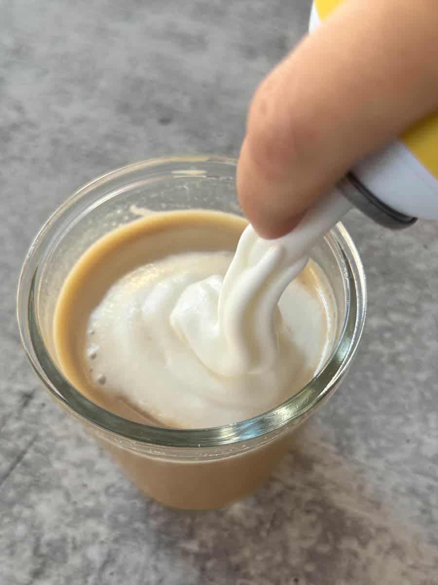 pouring cold foam in to a cup