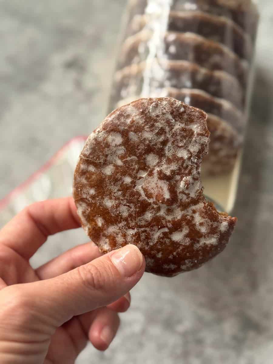 holding a brown cookie in hand