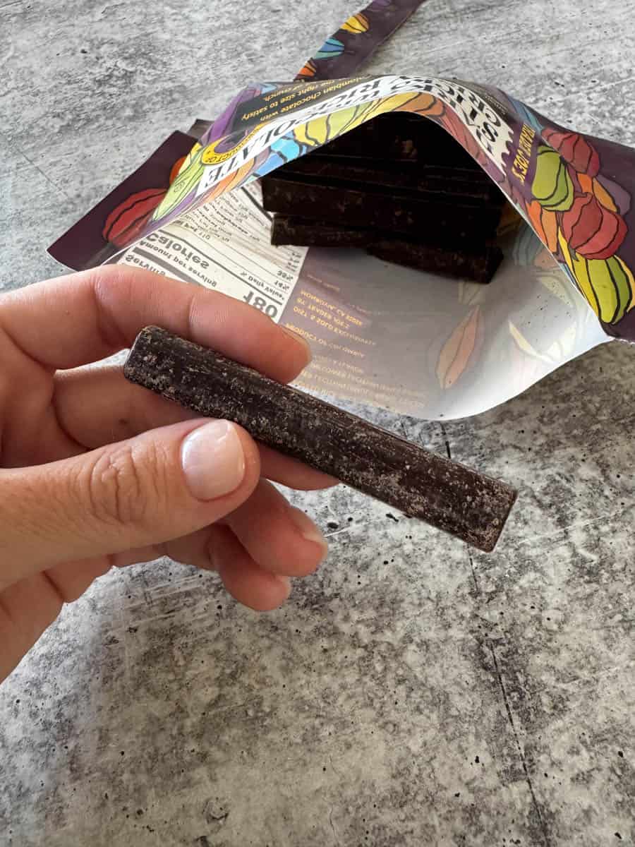 holding a chocolate stick in hand