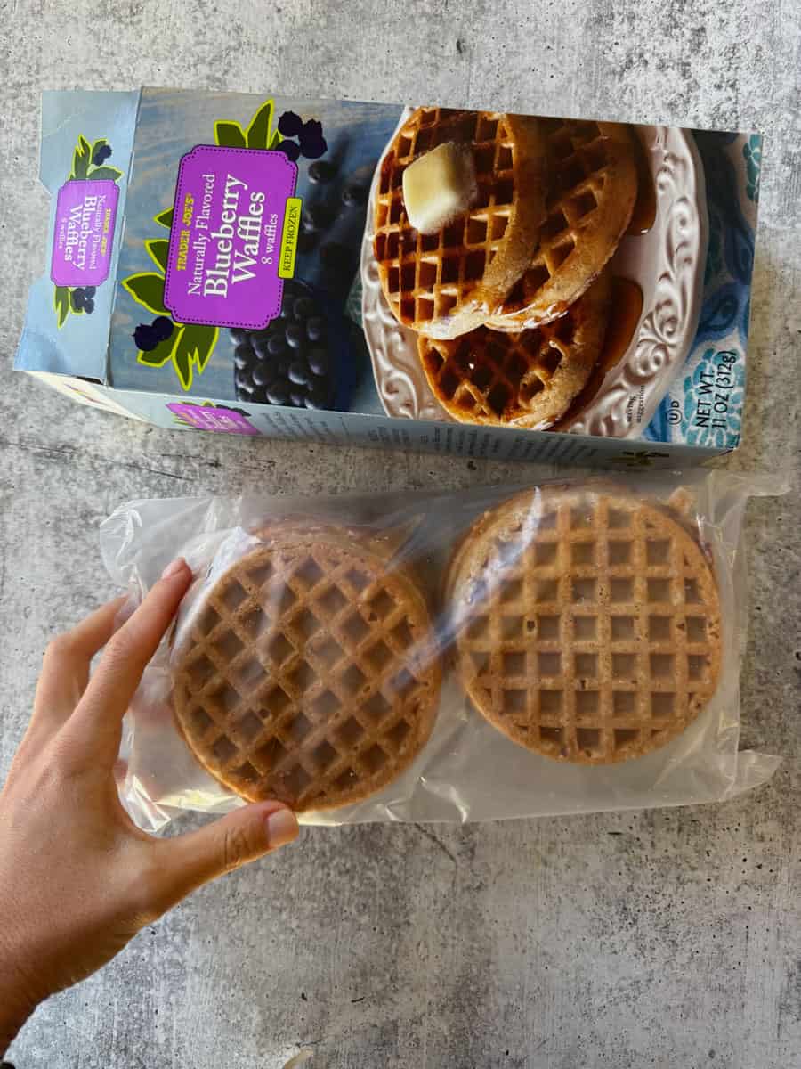 Pack of three golden blueberry waffles in clear plastic wrapping, ready to enjoy.