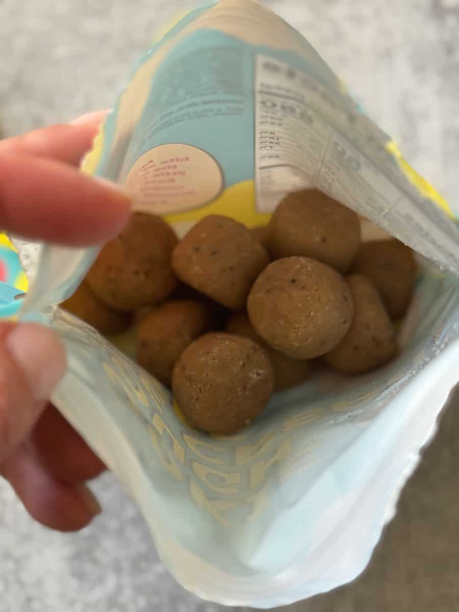 Close-up of cheese balls snack inside an open bag, ready to eat.