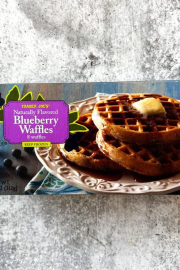 Pack of 8 Trader Eats blueberry flavored waffles, frozen and ready to cook.