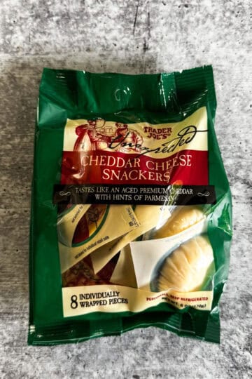 Cheddar cheese snackers in green packaging, individually wrapped, perfect for on-the-go snacking.