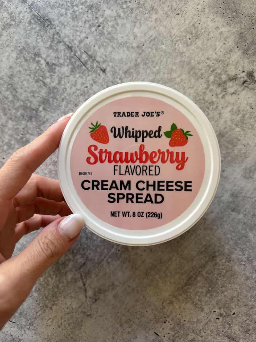 Trader Joe's whipped strawberry flavored cream cheese spread in a round container.