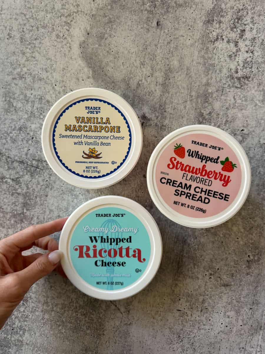 Assorted Trader Joe's flavored cream cheese spreads including vanilla mascarpone, strawberry, and ri.