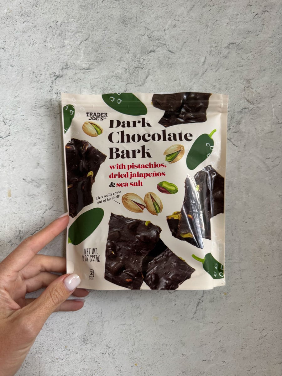 Trader Eats dark chocolate bark with pistachios, drizzled with sea salt, in a resealable bag.
