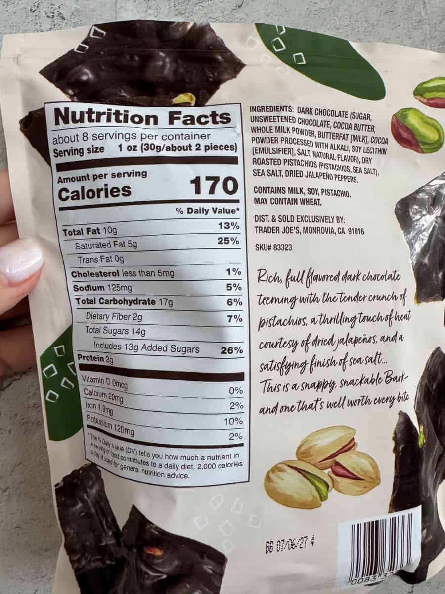 Dark chocolate snack bar with almonds and pistachios, rich flavor, and nutritional info.