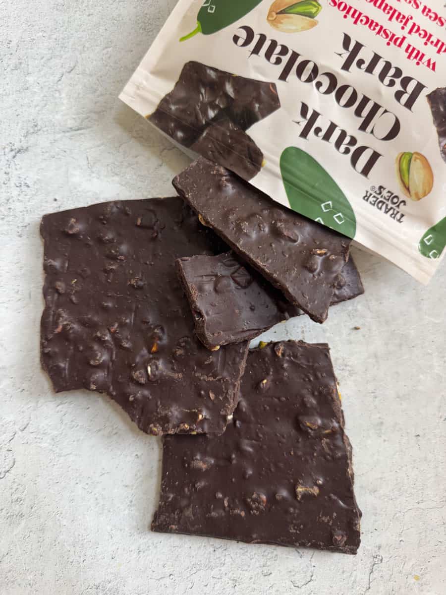 Dark chocolate bark with nuts from Trader Eats on a light surface.